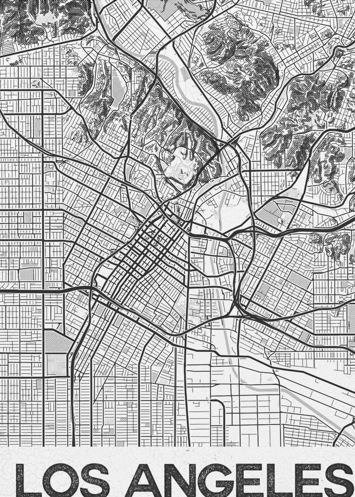 A modern, framed black and white map of Los Angeles. The detailed illustration features a dense grid of city streets, winding highways, rivers, and topographic details of hills. A white banner at the bottom displays the words 'LOS ANGELES' in a bold, black, textured font. Poster