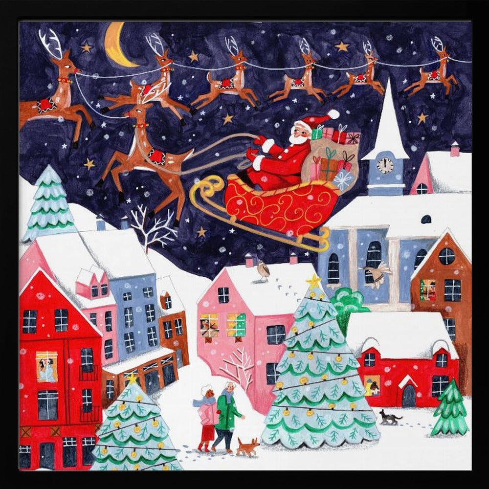 A festive illustration of Santa Claus flying in his sleigh pulled by reindeer over a snowy European-style village at night. The sky is a deep starry blue with a crescent moon, and the houses below are painted in vibrant reds, pinks, and blues, with warm light in the windows. People walk in the snow near decorated Christmas trees. Decor