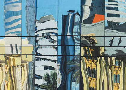 A framed abstract artwork showing a collage of distorted cityscape reflections in a grid of glass window panes. The reflections mix modern blue and white skyscrapers against a clear blue sky with older, golden-yellow buildings, creating a wavy and fragmented visual effect. Wall Art