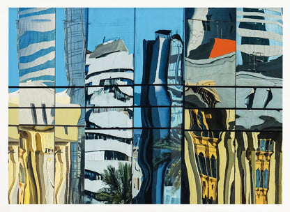 A framed abstract artwork showing a collage of distorted cityscape reflections in a grid of glass window panes. The reflections mix modern blue and white skyscrapers against a clear blue sky with older, golden-yellow buildings, creating a wavy and fragmented visual effect. Wall Art
