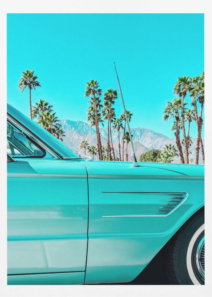 A vibrant, stylized photograph of a vintage turquoise car parked under a clear blue sky, with a row of tall palm trees and distant mountains creating a classic, sunny California scene. Wall Art