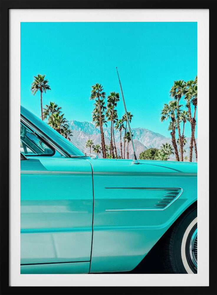 A vibrant, stylized photograph of a vintage turquoise car parked under a clear blue sky, with a row of tall palm trees and distant mountains creating a classic, sunny California scene. Wall Art