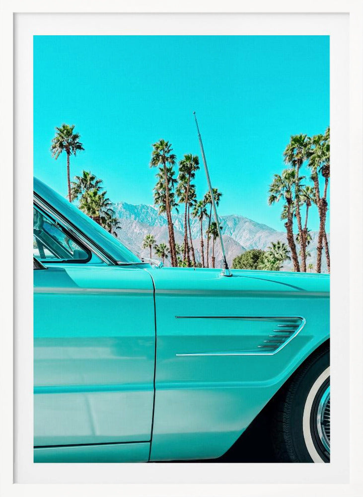 A vibrant, stylized photograph of a vintage turquoise car parked under a clear blue sky, with a row of tall palm trees and distant mountains creating a classic, sunny California scene. Wall Art