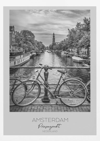 A black and white poster of the Prinsengracht canal in Amsterdam. A bicycle is parked on a bridge in the foreground, overlooking the canal lined with houseboats, trees, and traditional Dutch buildings. The Westerkerk church tower is visible in the distance. The poster has a white border with the words 'AMSTERDAM', 'Prinsengracht', and 'NEDERLAND' at the bottom. Poster