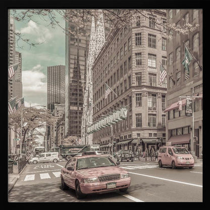 A framed photograph of a busy New York City street with a vintage, sepia-toned filter. Two cars, one in the foreground and one in the midground, are selectively colored a dusty pink, contrasting with the muted tones of the surrounding skyscrapers, American flags, and pedestrians. The sky is a pale teal color. Poster