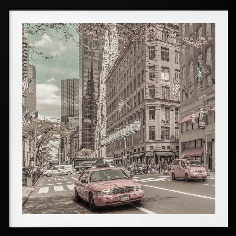 A framed photograph of a busy New York City street with a vintage, sepia-toned filter. Two cars, one in the foreground and one in the midground, are selectively colored a dusty pink, contrasting with the muted tones of the surrounding skyscrapers, American flags, and pedestrians. The sky is a pale teal color. Poster