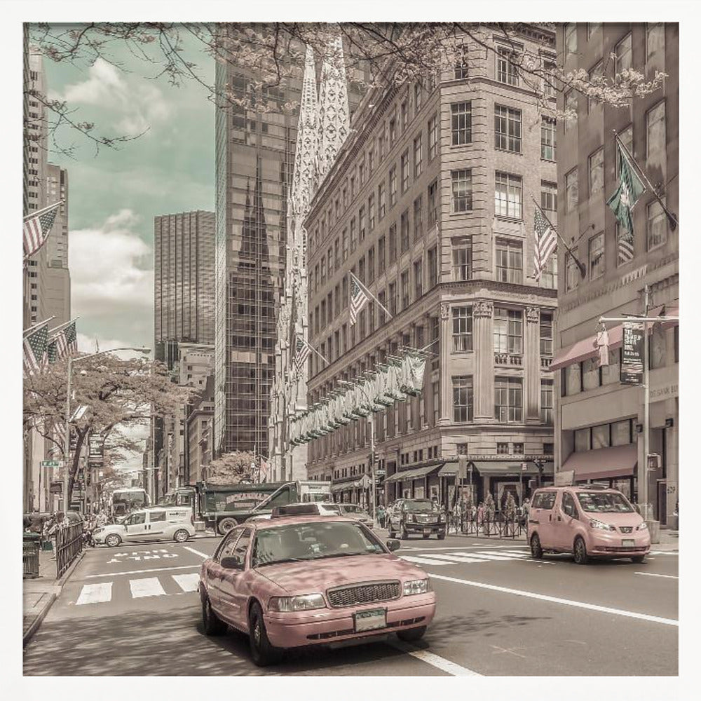 A framed photograph of a busy New York City street with a vintage, sepia-toned filter. Two cars, one in the foreground and one in the midground, are selectively colored a dusty pink, contrasting with the muted tones of the surrounding skyscrapers, American flags, and pedestrians. The sky is a pale teal color. Poster