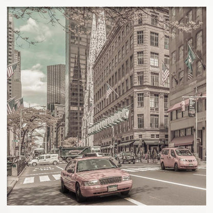 A framed photograph of a busy New York City street with a vintage, sepia-toned filter. Two cars, one in the foreground and one in the midground, are selectively colored a dusty pink, contrasting with the muted tones of the surrounding skyscrapers, American flags, and pedestrians. The sky is a pale teal color. Poster