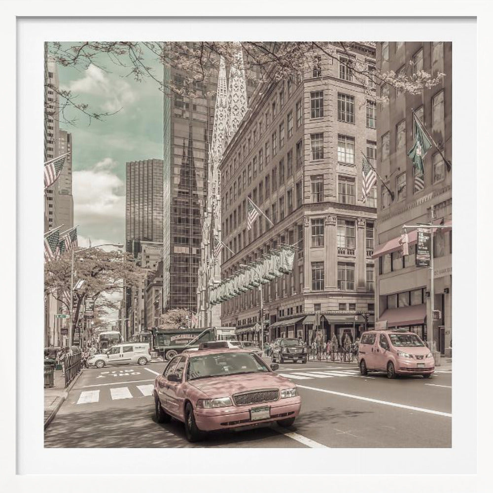 A framed photograph of a busy New York City street with a vintage, sepia-toned filter. Two cars, one in the foreground and one in the midground, are selectively colored a dusty pink, contrasting with the muted tones of the surrounding skyscrapers, American flags, and pedestrians. The sky is a pale teal color. Poster