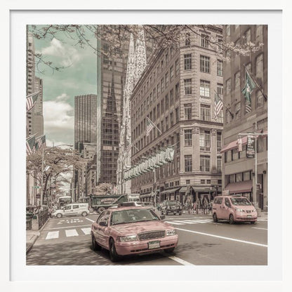 A framed photograph of a busy New York City street with a vintage, sepia-toned filter. Two cars, one in the foreground and one in the midground, are selectively colored a dusty pink, contrasting with the muted tones of the surrounding skyscrapers, American flags, and pedestrians. The sky is a pale teal color. Poster