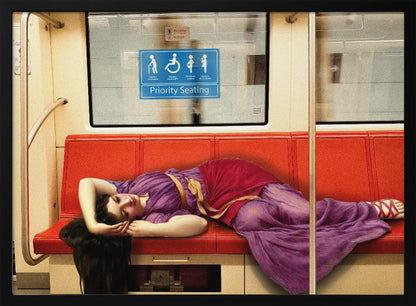 A framed surrealist artwork depicting a woman in a classical purple and red toga sleeping across a row of modern red subway seats. Above her on the window is a blue 'Priority Seating' sign, creating a humorous juxtaposition between ancient and modern life. Artwork