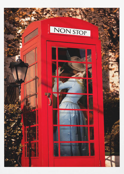 A couple in vintage clothing share a passionate kiss inside a classic bright red telephone booth. The woman is wearing a light blue dress, and the man wears a hat. The sign above the booth door reads 'NON STOP'. The setting appears to be outdoors in autumn. Wall Art
