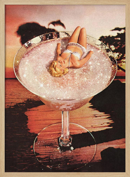 A surreal collage featuring a blonde woman in a white bikini lounging in a giant cocktail glass filled with a sparkling pink liquid, set against a warm sunset over the ocean. Print