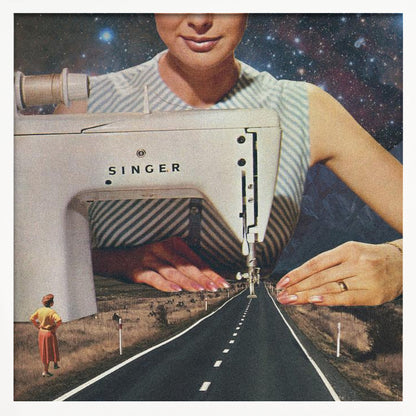 A surreal collage in a light wood frame featuring a giant woman in a striped dress using a vintage Singer sewing machine to stitch the white dashed lines onto an empty road that stretches into the distance. The background behind the woman is a starry galaxy, and a small woman in vintage clothing stands on the side of the road looking on. Print