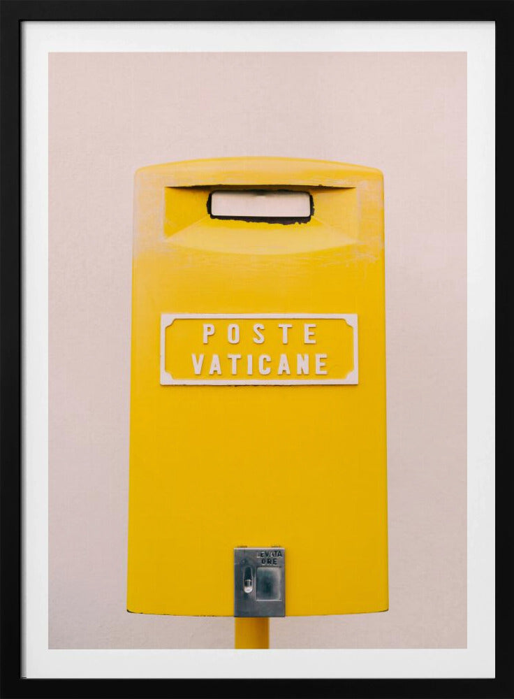 A close-up, front-view photograph of a vibrant yellow Vatican City mailbox against a plain beige wall, enclosed in a thin black frame. The words 'POSTE VATICANE' are printed in white on the front. Artwork