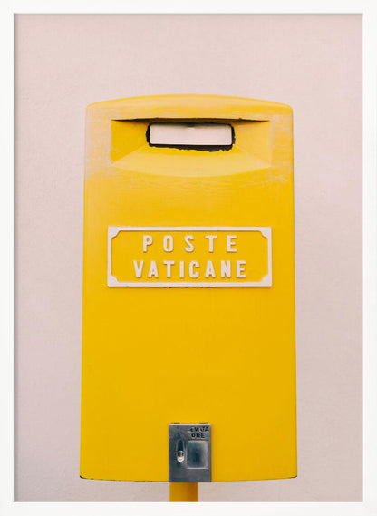 A close-up, front-view photograph of a vibrant yellow Vatican City mailbox against a plain beige wall, enclosed in a thin black frame. The words 'POSTE VATICANE' are printed in white on the front. Artwork