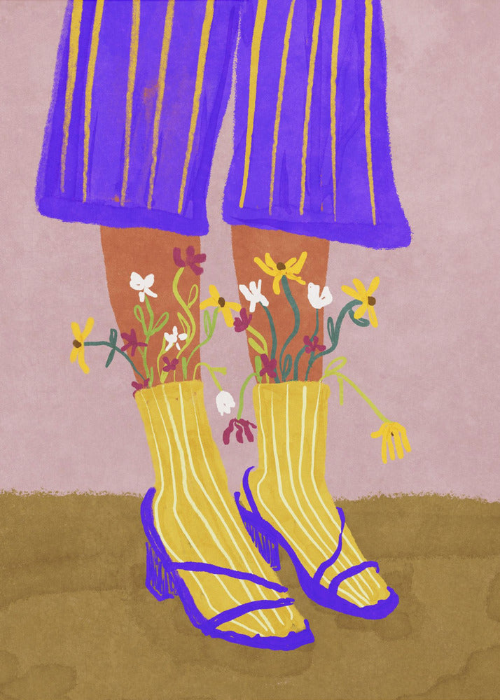 A stylized, colorful illustration focusing on the lower legs and feet of a person wearing vibrant clothing. They have on wide-legged, royal blue trousers with vertical yellow stripes, and yellow socks with white stripes. Small, colorful wildflowers sprout from the tops of their socks. They are wearing bright blue strappy heeled sandals. The background is a soft pink color with a brown floor. Wall Art