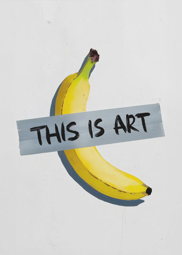 A framed artwork depicting a single yellow banana taped to a white wall with a grey strip of tape that reads 'THIS IS ART' in black marker-style font. Artwork