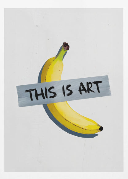 A framed artwork depicting a single yellow banana taped to a white wall with a grey strip of tape that reads 'THIS IS ART' in black marker-style font. Artwork