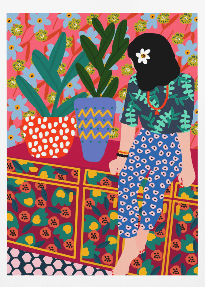 A colorful, maximalist illustration of a woman with black hair and a flower, sitting on a patterned cabinet. She wears a dark blue shirt with green leaves and blue pants with white circles. Next to her are two potted plants in brightly patterned pots, set against a pink and blue floral wallpaper. Poster