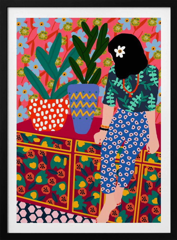 A colorful, maximalist illustration of a woman with black hair and a flower, sitting on a patterned cabinet. She wears a dark blue shirt with green leaves and blue pants with white circles. Next to her are two potted plants in brightly patterned pots, set against a pink and blue floral wallpaper. Poster
