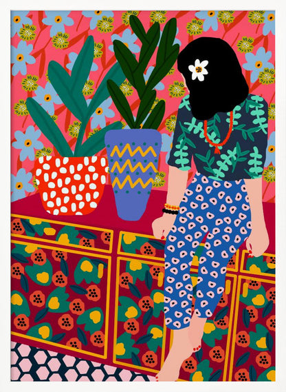 A colorful, maximalist illustration of a woman with black hair and a flower, sitting on a patterned cabinet. She wears a dark blue shirt with green leaves and blue pants with white circles. Next to her are two potted plants in brightly patterned pots, set against a pink and blue floral wallpaper. Poster