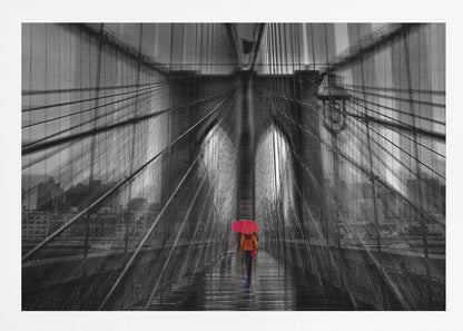 A motion-blurred, black and white photo of the Brooklyn Bridge with a person holding a bright red umbrella walking down the center. The selective color makes the red umbrella the focal point against the dramatic, almost abstract lines of the bridge's cables and arches on a wet, reflective walkway. The image is presented in a silver frame. Wall Art