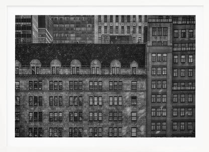 A dense, black and white photograph of various city buildings packed closely together. The image highlights the contrasting architectural styles, from an older stone building with a dark roof in the foreground to taller brick and modern glass buildings in the background, creating a geometric pattern of windows and textures. Decor