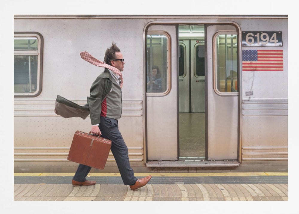 A stylish man with windblown hair and a flying scarf walks briskly along a subway platform, carrying a brown briefcase next to a silver train. Artwork