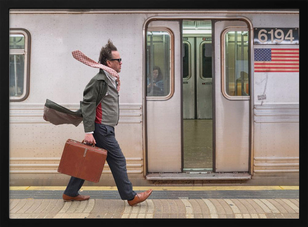 A stylish man with windblown hair and a flying scarf walks briskly along a subway platform, carrying a brown briefcase next to a silver train. Artwork