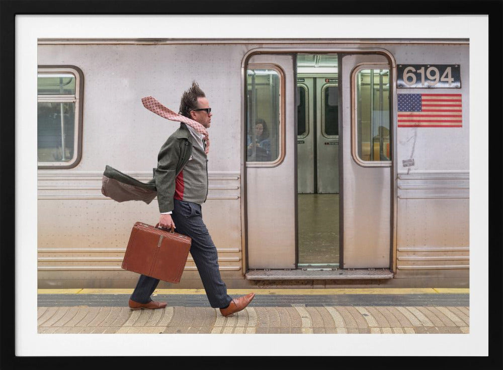 A stylish man with windblown hair and a flying scarf walks briskly along a subway platform, carrying a brown briefcase next to a silver train. Artwork
