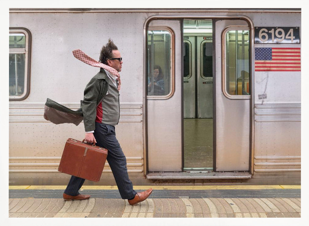 A stylish man with windblown hair and a flying scarf walks briskly along a subway platform, carrying a brown briefcase next to a silver train. Artwork