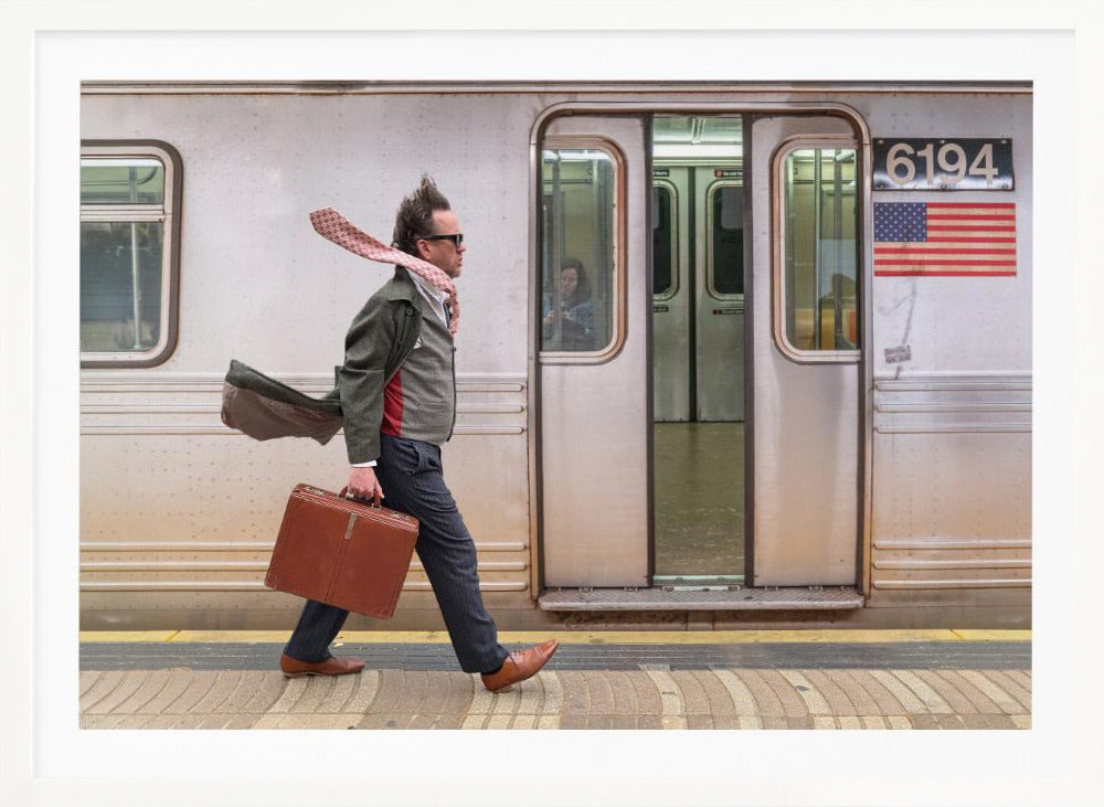 A stylish man with windblown hair and a flying scarf walks briskly along a subway platform, carrying a brown briefcase next to a silver train. Artwork