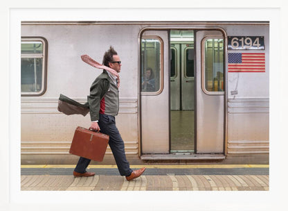 A stylish man with windblown hair and a flying scarf walks briskly along a subway platform, carrying a brown briefcase next to a silver train. Artwork