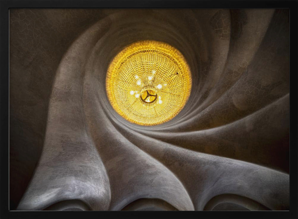 A worm's-eye view of an ornate, golden chandelier set against a swirling, textured dark grey ceiling. The spiraling architectural feature draws the eye to the brightly lit fixture, creating an abstract and dramatic composition. Poster