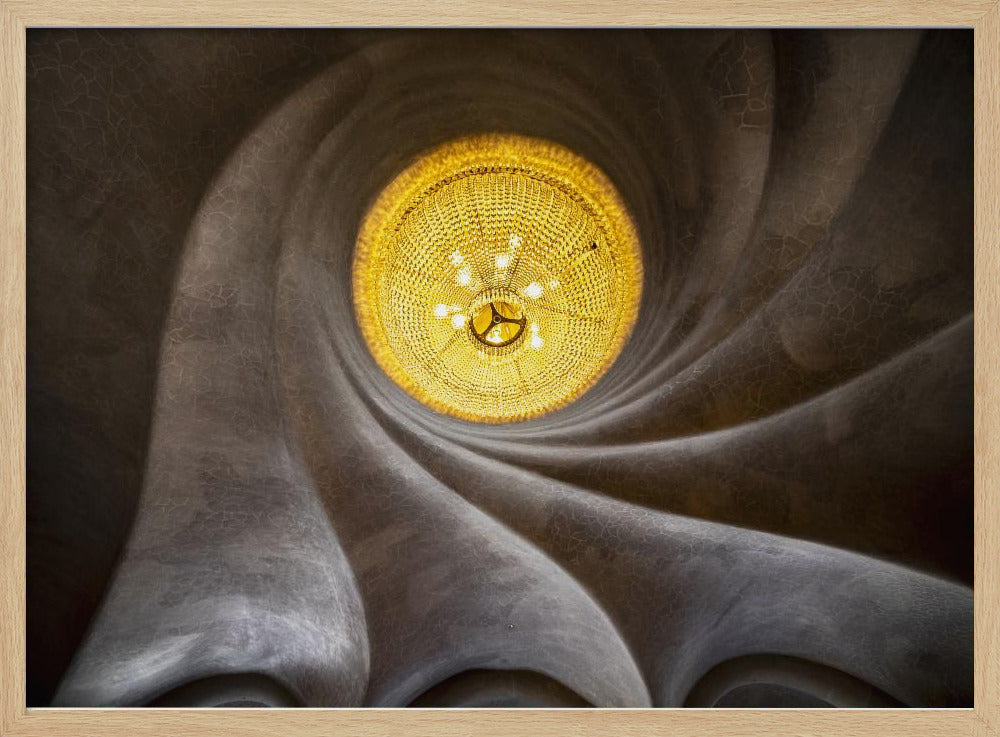 A worm's-eye view of an ornate, golden chandelier set against a swirling, textured dark grey ceiling. The spiraling architectural feature draws the eye to the brightly lit fixture, creating an abstract and dramatic composition. Poster