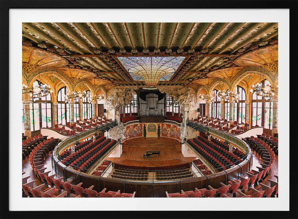 A high-angle, wide shot of the ornate and lavish interior of the Palau de la Música Catalana in Barcelona. The view captures the entire concert hall, with its curved balconies filled with red seats, a central wooden stage with a grand piano, and a spectacular, large stained-glass skylight in the ceiling. Poster