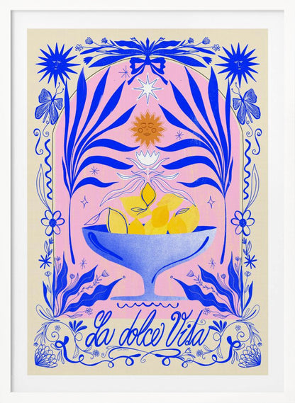A vibrant, symmetrical illustration featuring a blue bowl of yellow lemons set against a pink arched background. The scene is framed by elaborate blue botanicals, flowers, butterflies, and celestial symbols like suns with faces. At the bottom, the phrase 'La dolce Vita' is written in elegant blue script. Decor