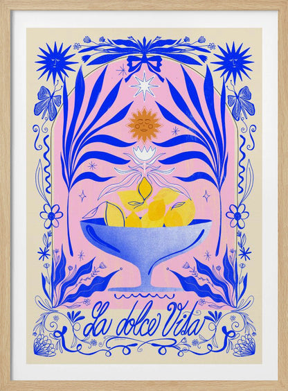 A vibrant, symmetrical illustration featuring a blue bowl of yellow lemons set against a pink arched background. The scene is framed by elaborate blue botanicals, flowers, butterflies, and celestial symbols like suns with faces. At the bottom, the phrase 'La dolce Vita' is written in elegant blue script. Decor