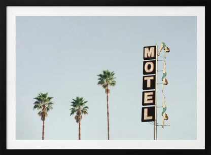 A minimalist photograph featuring three tall palm trees and a vertical black and white 'MOTEL' sign against a pale blue sky. Affixed to the sign's pole are several figures of women in green swimsuits, posed as if diving in a synchronized formation. Poster