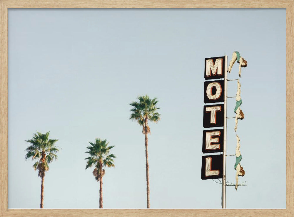 A minimalist photograph featuring three tall palm trees and a vertical black and white 'MOTEL' sign against a pale blue sky. Affixed to the sign's pole are several figures of women in green swimsuits, posed as if diving in a synchronized formation. Poster