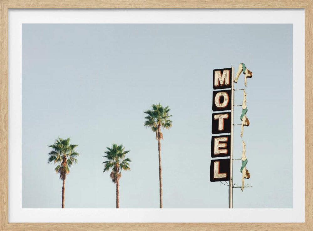 A minimalist photograph featuring three tall palm trees and a vertical black and white 'MOTEL' sign against a pale blue sky. Affixed to the sign's pole are several figures of women in green swimsuits, posed as if diving in a synchronized formation. Poster