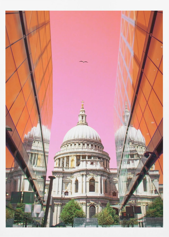 A low-angle, surrealist photograph of a classic white dome cathedral, framed perfectly between two modern orange glass buildings. The cathedral's reflection is visible on the buildings' surfaces against a vibrant, solid pink sky with a lone bird in flight. Poster