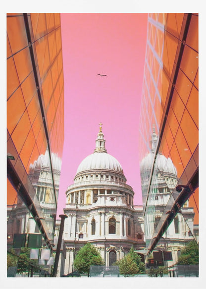 A low-angle, surrealist photograph of a classic white dome cathedral, framed perfectly between two modern orange glass buildings. The cathedral's reflection is visible on the buildings' surfaces against a vibrant, solid pink sky with a lone bird in flight. Poster
