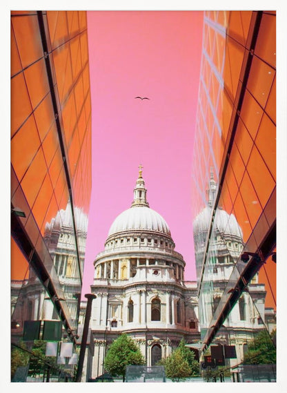 A low-angle, surrealist photograph of a classic white dome cathedral, framed perfectly between two modern orange glass buildings. The cathedral's reflection is visible on the buildings' surfaces against a vibrant, solid pink sky with a lone bird in flight. Poster