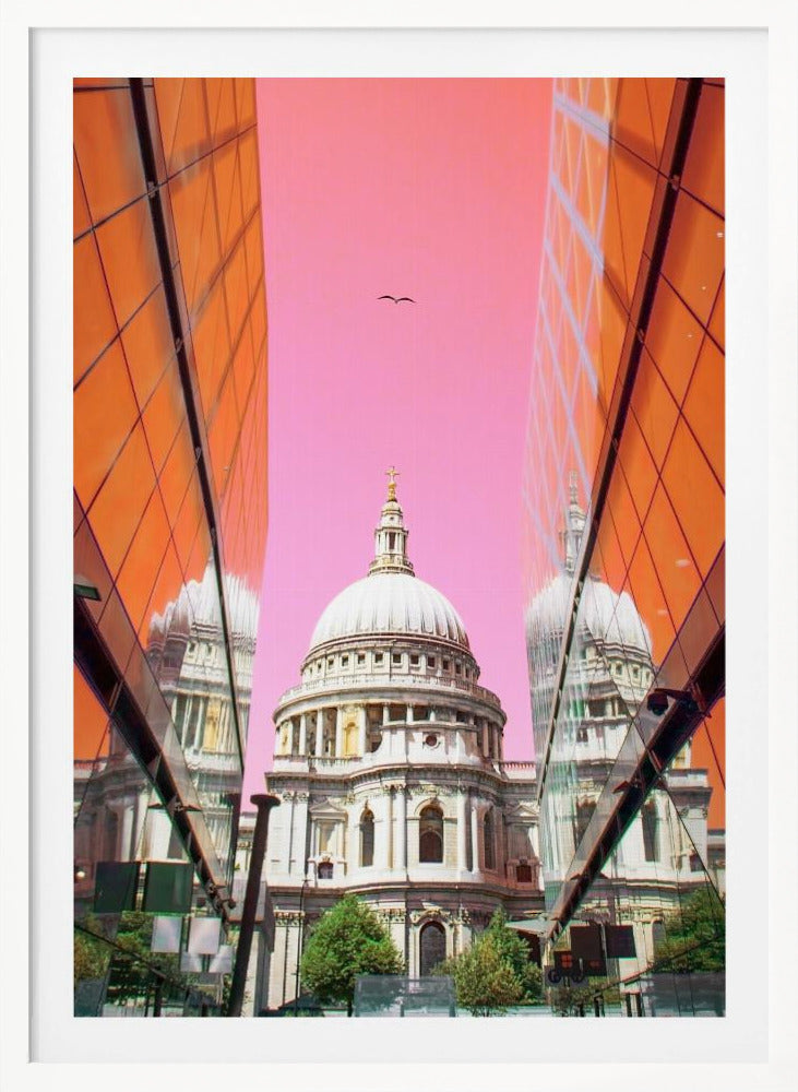 A low-angle, surrealist photograph of a classic white dome cathedral, framed perfectly between two modern orange glass buildings. The cathedral's reflection is visible on the buildings' surfaces against a vibrant, solid pink sky with a lone bird in flight. Poster