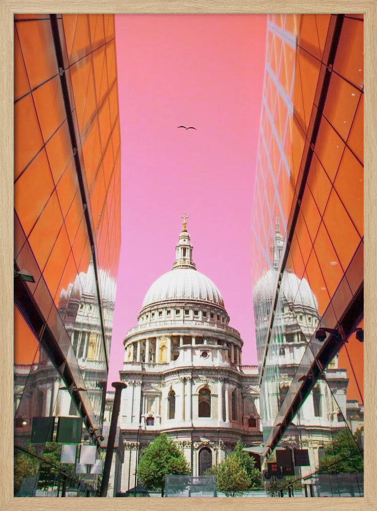 A low-angle, surrealist photograph of a classic white dome cathedral, framed perfectly between two modern orange glass buildings. The cathedral's reflection is visible on the buildings' surfaces against a vibrant, solid pink sky with a lone bird in flight. Poster