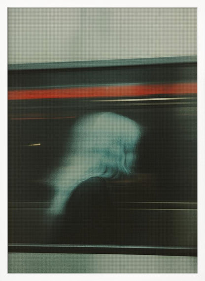 An abstract photograph with motion blur, featuring the ghostly silhouette of a person's head and shoulders in pale blue. The dark background is streaked with horizontal lines of red and white light, suggesting the speed of a passing train or subway. Wall Art