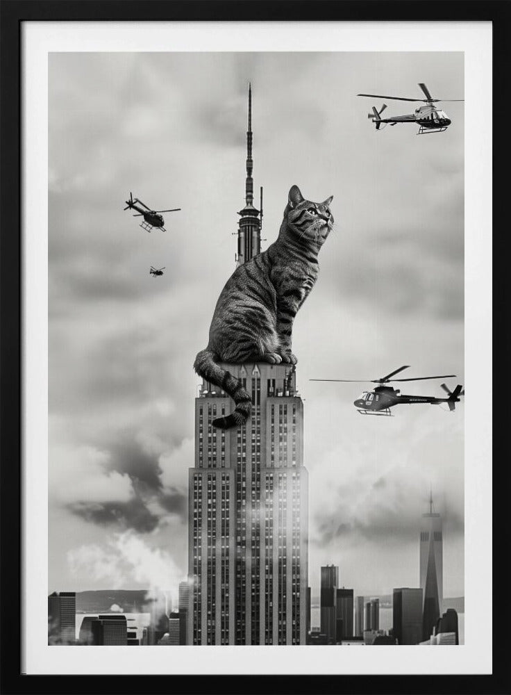 A surreal black and white image depicting a giant tabby cat sitting on top of the Empire State Building, similar to King Kong. Helicopters fly around the colossal cat against a cloudy New York City skyline. Decor