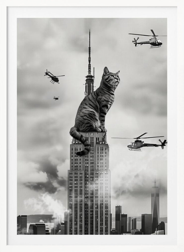 A surreal black and white image depicting a giant tabby cat sitting on top of the Empire State Building, similar to King Kong. Helicopters fly around the colossal cat against a cloudy New York City skyline. Decor